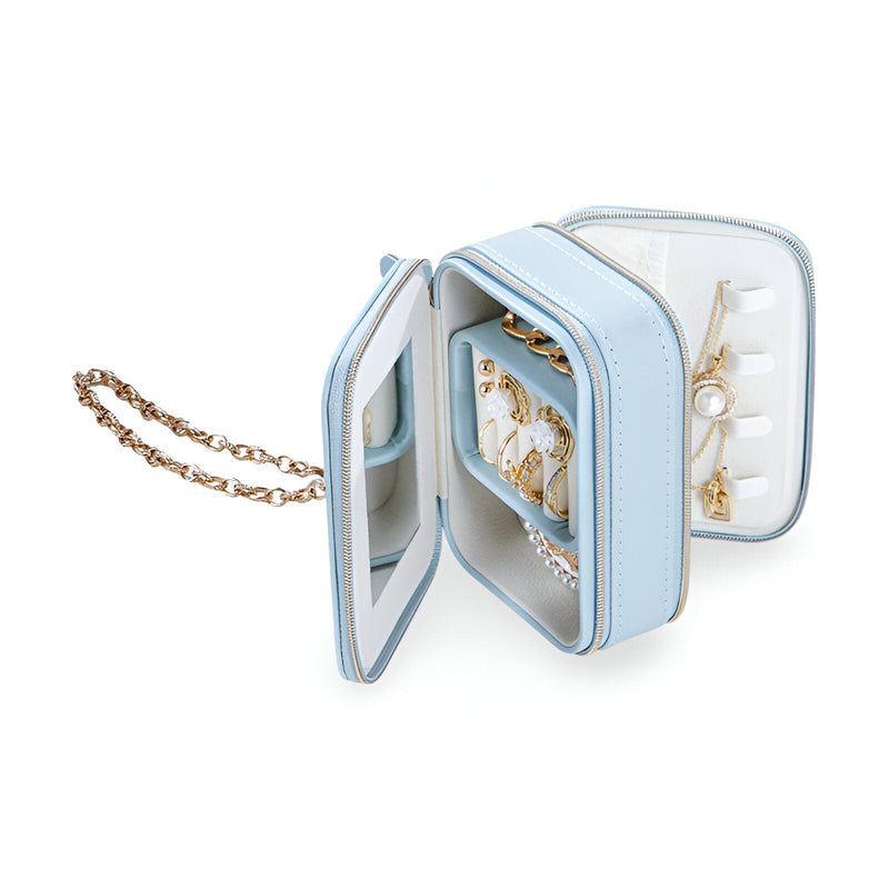 Boîte à bijoux bleue en forme de sac à main avec miroir intérieur et rangement pour bijoux, chaîne dorée élégante.