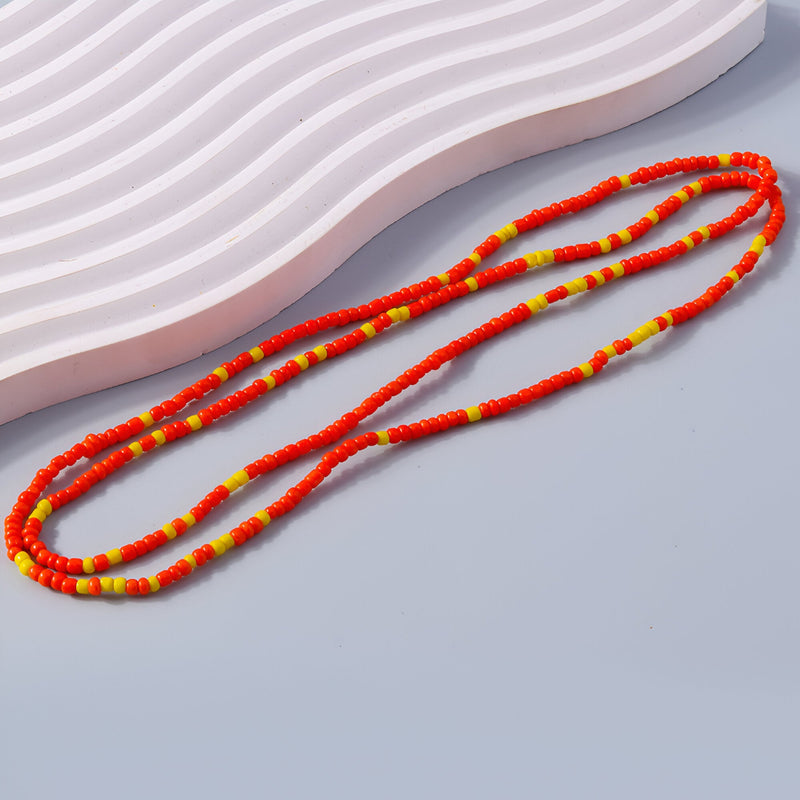 Bracelet à enrouler en perles de résine rouges et jaunes, style fin et coloré pour femme.