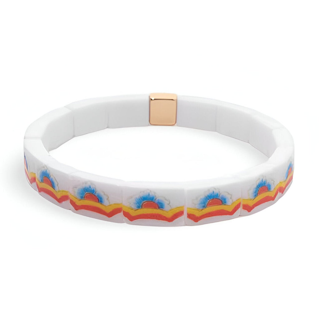 Bracelet en acrylique blanc avec motif floral coloré bleu, orange et rouge, fermoir doré.