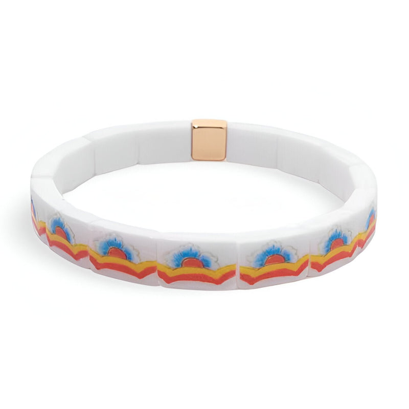 Bracelet en acrylique blanc avec motif floral coloré bleu, orange et rouge, fermoir doré.