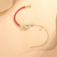 Bracelet rouge en fil nylon avec pierre de jade ovale et chaîne réglable en argent 925.