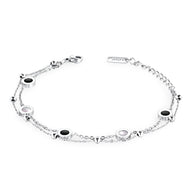 Bracelet fin ajustable en argent avec petits motifs ronds noirs et blancs espacés sur chaîne délicate.