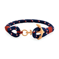 Bracelet ancre pour homme en coton bleu marine avec motifs rouges et ancre en acier inoxydable doré.