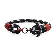 Bracelet ancre noir et blanc en coton avec détails rouges et fermoir ancre en acier inoxydable.