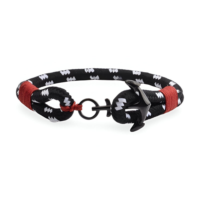 Bracelet ancre noir et blanc en coton avec détails rouges et fermoir ancre en acier inoxydable.