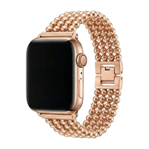 Bracelet Apple Watch en acier inoxydable rose doré, finition perles métalliques, fermoir cliquet sécurisé, design élégant et