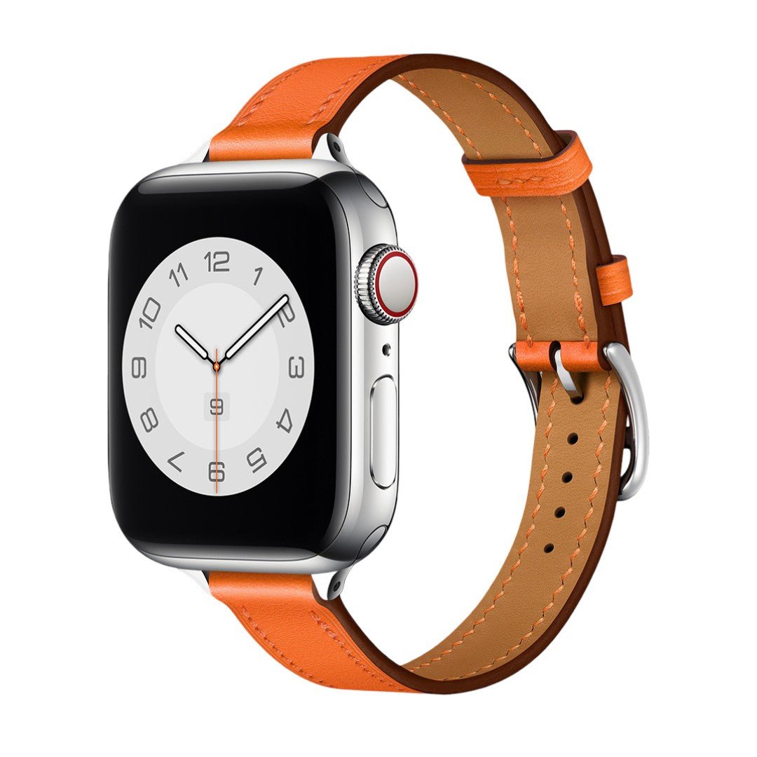 Bracelet Apple Watch en cuir orange vif avec couture apparente blanche, boucle argentée, style raffiné et ajustable.