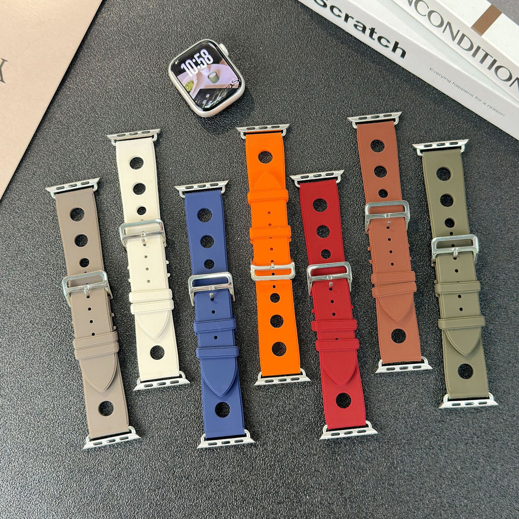 Lot de six bracelets Apple Watch en silicone perforé, couleurs beige, blanc, bleu, orange, rouge et kaki, fermoirs en acier.