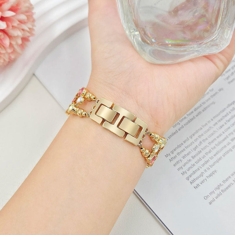 Apple Watch-armbånd til kvinder i forgyldt legering, justerbare led med kliklås, smykke med farvede sten, elegant tilbehør til smartwatch, model Bestine