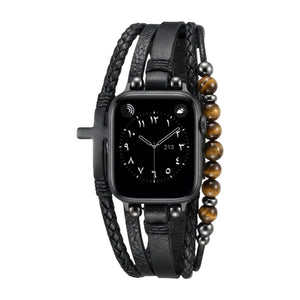 Bracelet Apple Watch multi-rangs en simili cuir vegan noir avec perles œil de tigre et croix noire, fermoir ajustable.