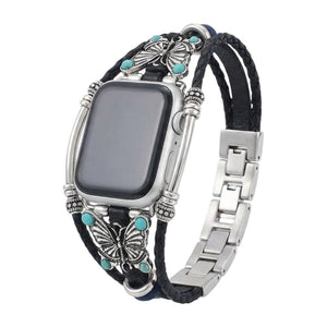 Bracelet Apple Watch noir en simili cuir tressé, papillons argentés et perles turquoise, fermoir métal argenté élégant.