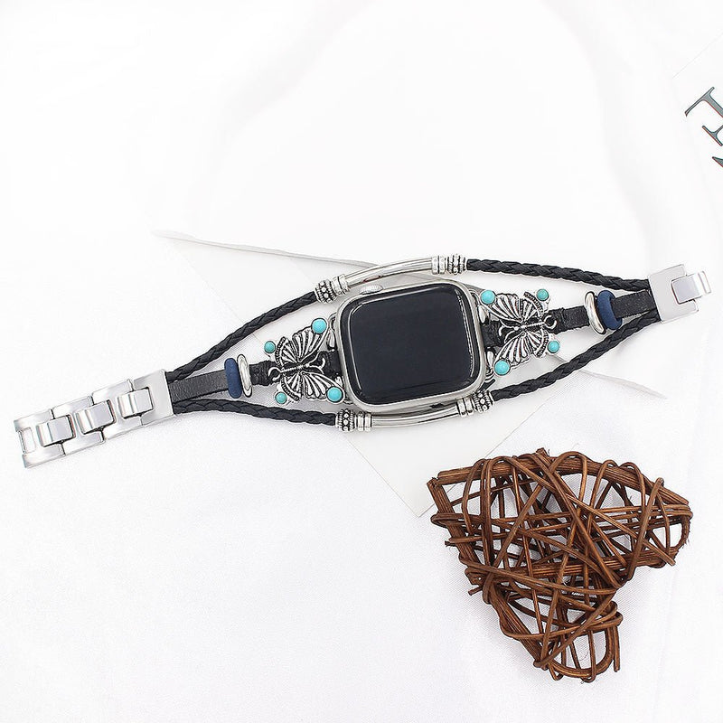 Bracelet Apple Watch noir tressé en simili cuir vegan avec papillon argenté et perles turquoise, fermoir métallique argenté.