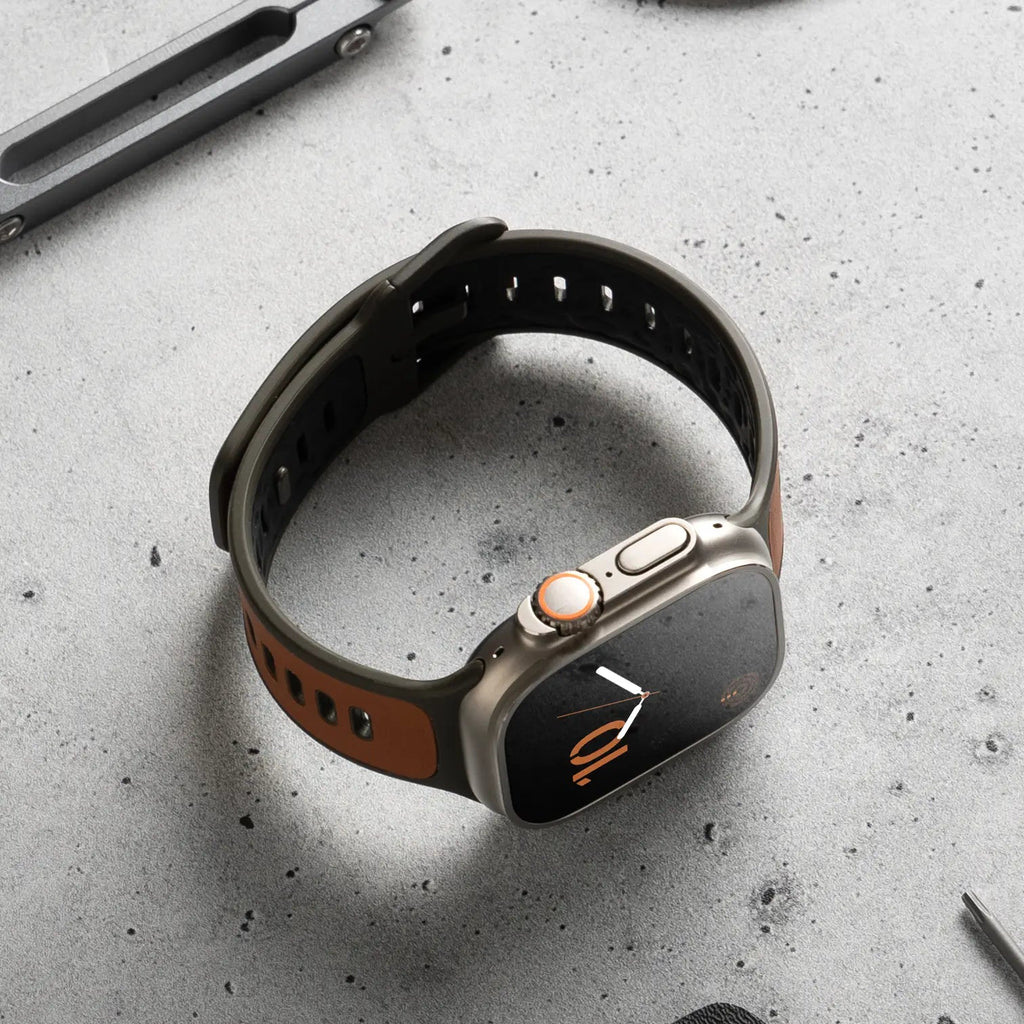 Bracelet Apple Watch hybride cuir marron et fluoroélastomère noir avec boucle ajustable.