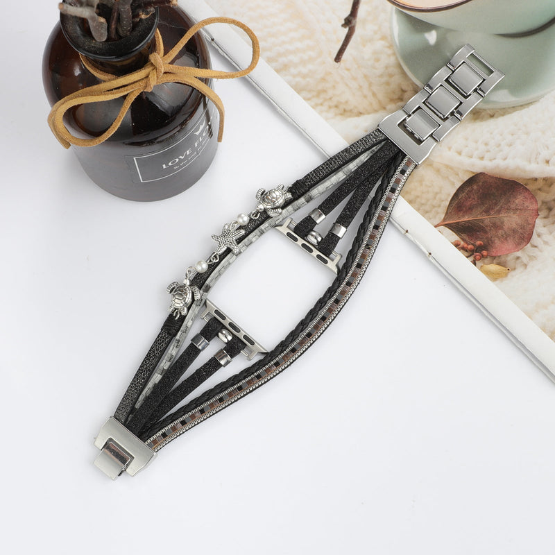 Bracelet Apple Watch noir style tropical chic en simili vegan avec tortue, étoile de mer et perles argentées.