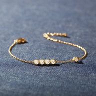 Bracelet fin en argent sterling avec cinq pierres scintillantes serties sur une chaîne délicate.