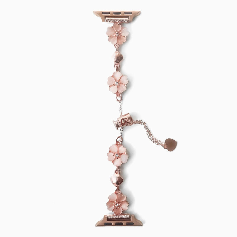 Bracelet chaîne en métal rose orné de fleurs de cerisier pour Apple Watch, style délicat et féminin.