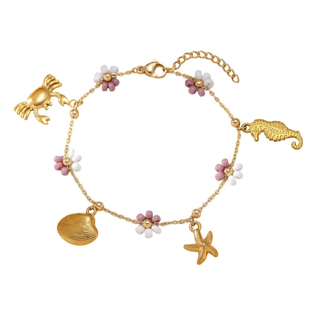 Bracelet doré en acier inoxydable avec charms soleil, crabe, hippocampe, étoile de mer et coquillage, orné de petites fleurs