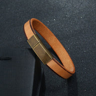 Bracelet en cuir cognac avec fermoir magnétique en métal vieilli, style chic pour homme.