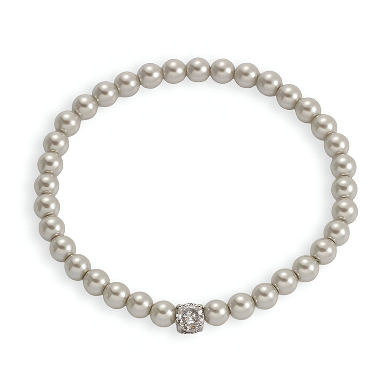 Bracelet femme en perles d'imitation blanches avec un strass central scintillant.