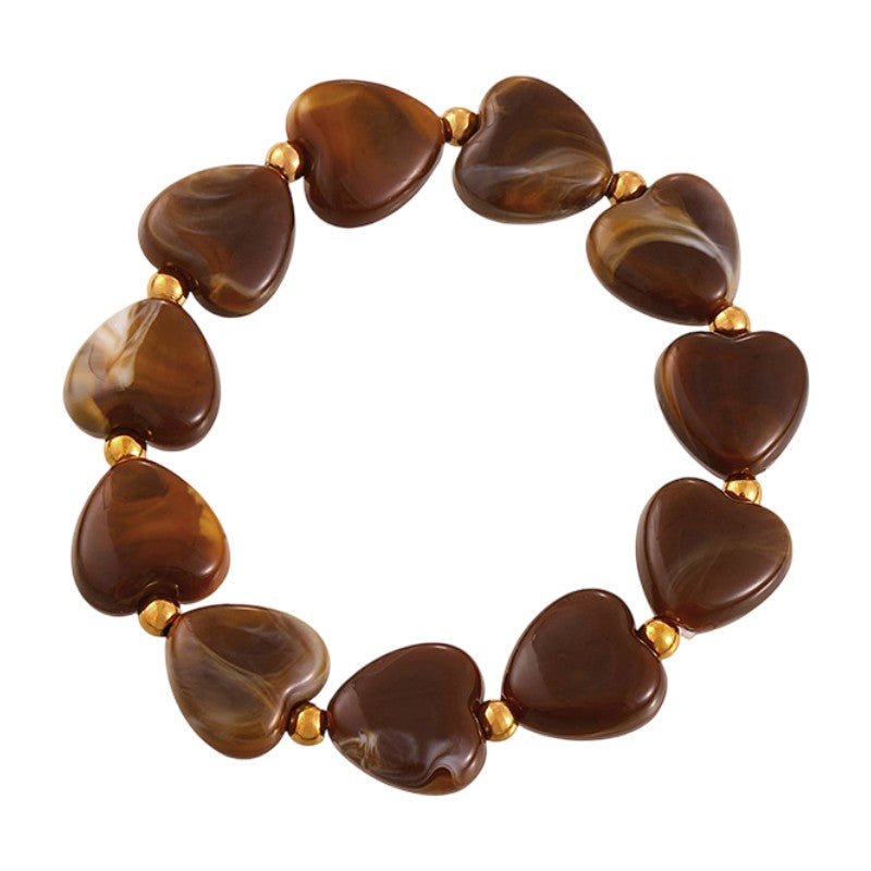 Armband med hjärtformade pärlor i marmorliknande resin, guldfärgade mellanlägg i stål, modell Aroba