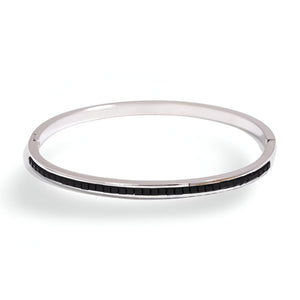 Bracelet fin rigide en acier inoxydable avec incrustation noire brillante, style épuré pour femme.