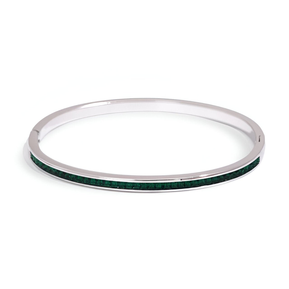 Bracelet fin en acier inoxydable argenté avec incrustation verte lumineuse pour femme.