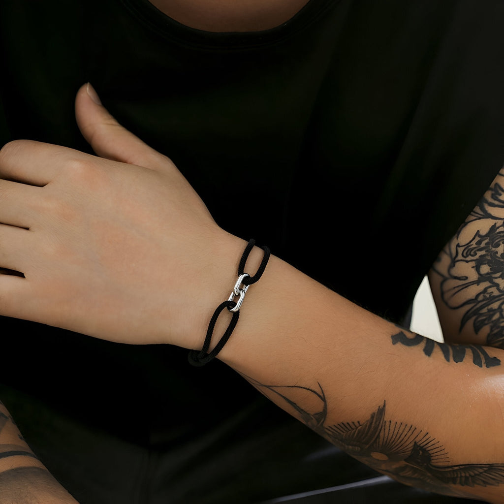 Bracelet cordon noir avec maillons croisés en métal argenté élégant pour homme et femme.