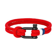 Bracelet cordon rouge avec manille noire et détail rouge et blanc en nylon tressé.