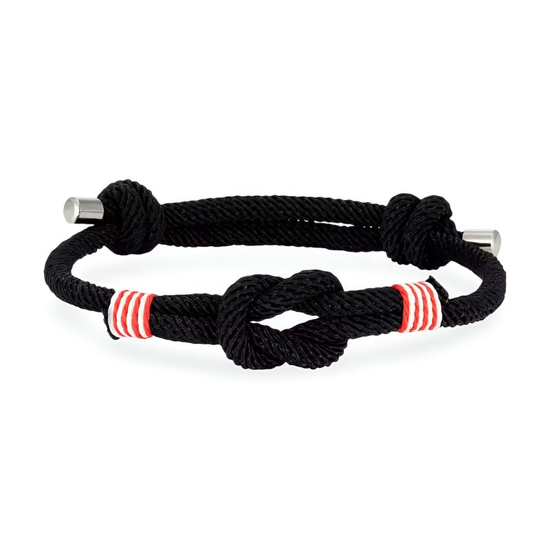 Bracelet cordon noir ajustable avec nœud central et rayures rouges et blanches.