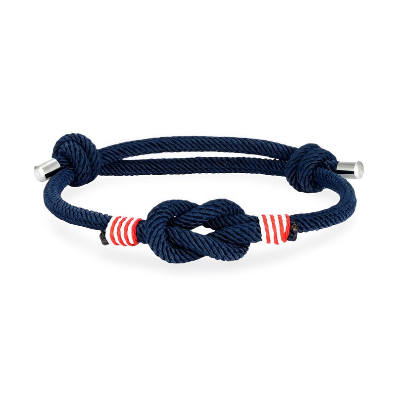 Bracelet cordon bleu marine à nœud central et rayures rouges ajustable avec embouts métalliques.