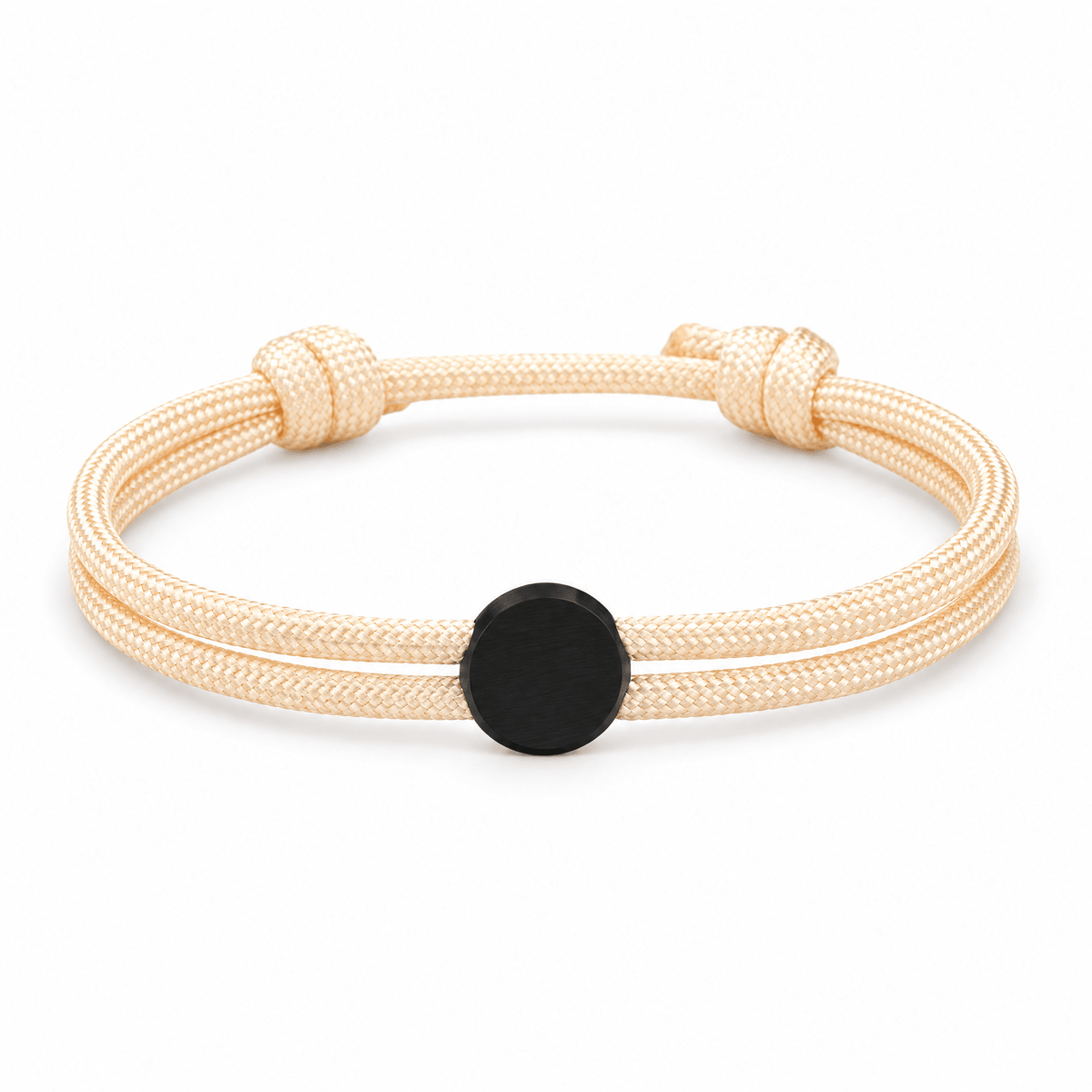 Bracelet Marsin Blanc crème et noir, cordon ajustable et pastille ronde, posé de face sur fond blanc