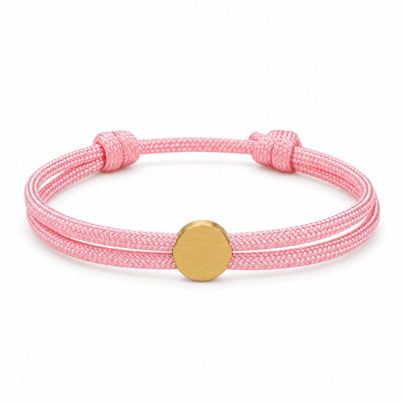 Bracelet Marsin Rose et or, cordon ajustable et pastille ronde, posé de face sur fond blanc