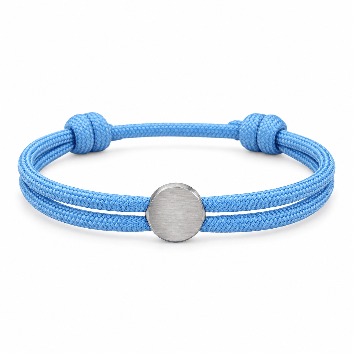 Bracelet Marsin Bleu clair et argent, cordon ajustable et pastille ronde, posé de face sur fond blanc