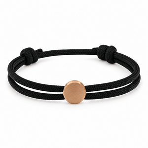 Bracelet Marsin Noir et or rosé, cordon ajustable et pastille ronde, posé de face sur fond blanc