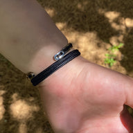 Bracelet cordon bleu marine avec fermoir en argent sterling, modèle Vincent, porté au poignet.