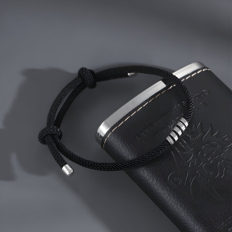 Bracelet cordon noir minimaliste avec extrémités en titane brillant pour homme.