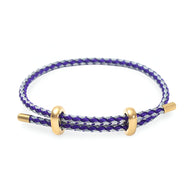 Bracelet cordon violet et gris avec détails en acier inoxydable doré, style authentique.