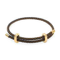 Bracelet cordon noir tressé avec anneaux et fermoir en acier inoxydable doré.