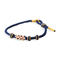 Bracelet cordon bleu foncé avec motif floral rose et blanc en perles, fermoir doré.