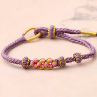 Bracelet cordon lavande avec motif floral rose et jaune, style ajustable pour femme.