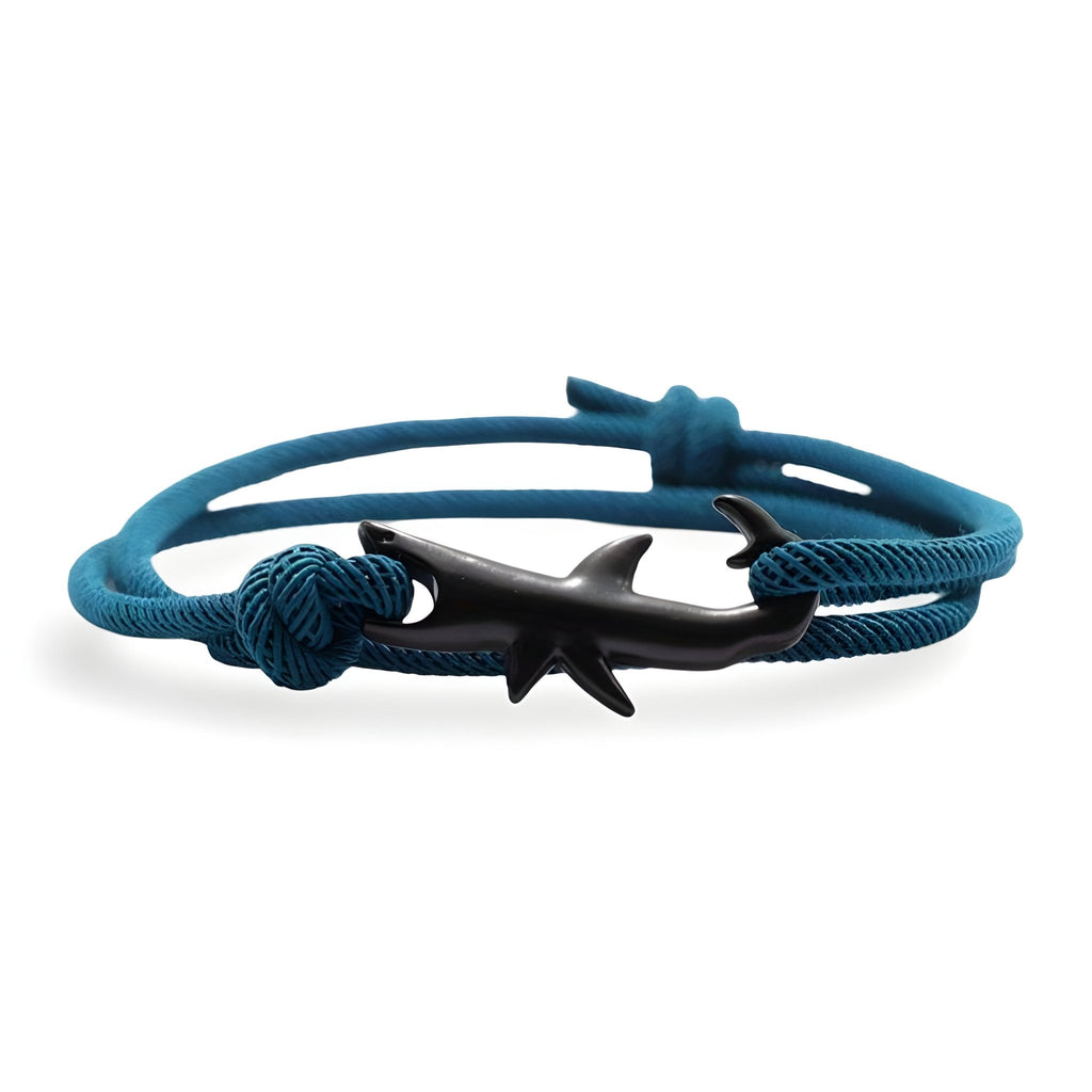 Bracelet cordon bleu turquoise avec motif requin noir en métal et nœuds décoratifs.