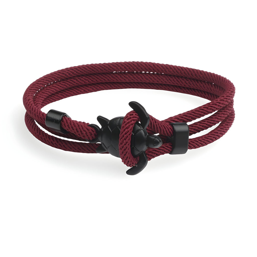 Bracelet cordon bordeaux à motif tortue en métal noir, style marin élégant.