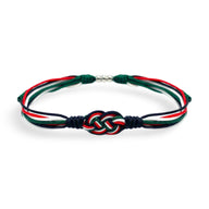 Bracelet cordon tricolore à nœud décoratif aux couleurs rouge, vert, blanc et noir, style Clove.