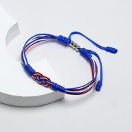 Bracelet cordon bleu et rouge avec noeud plat couleur drapeau France et fermoir métal argenté.