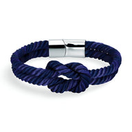 Bracelet cordon bleu marine épais avec nœud et fermoir métallique argenté lisse.