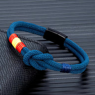Bracelet cordon bleu marine avec noeud et drapeau espagnol rouge-jaune-rouge, fermoir noir brillant.