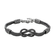 Bracelet cordon gris en argent sterling tressé avec noeud central et fermoir lobster.