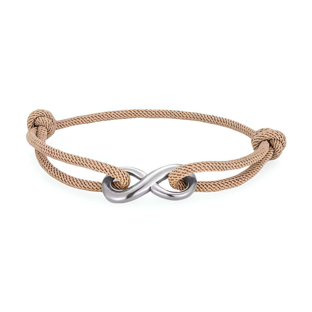 Bracelet cordon beige avec ornement infini en métal argenté, ajustable avec nœuds coulissants.