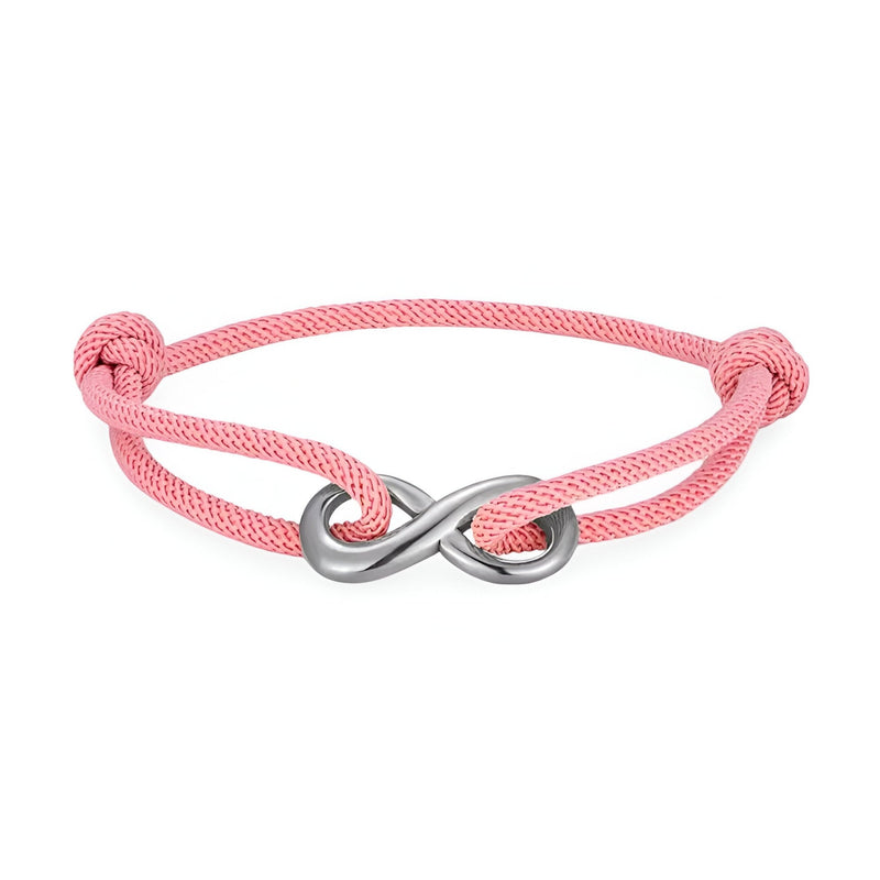 Bracelet cordon rose avec ornement infini en métal argenté, ajustable avec nœuds coulissants.