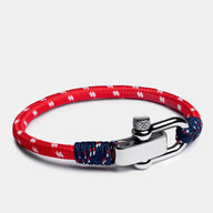 Bracelet cordon rouge et bleu à motifs blancs, fermoir mousqueton en acier argenté mat.